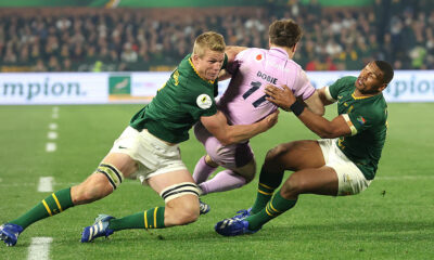 PRETORIA, SOUTH AFRICA - JULY 11: Jamie Dobie of Scotland is tackled by Pieter-Steph du Toit (L) and Damian Willemse during the 2026 Nations Championship match between South Africa and Scotland at Loftus Versfeld Stadium on July 11, 2026 in Pretoria, South Africa. (Photo by David Rogers/Getty Images)