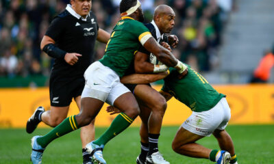 Mark Tele'a of the All Blacks tackled by Damian de Allende and Siya Kolisi (captain) of the Springboks during the Castle Lager Rugby Championship match between South Africa and New Zealand at DHL Stadium on September 07, 2024 in Cape Town, South Africa. (Photo by Ashley Vlotman/Gallo Images/Getty Images)